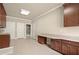 Spacious laundry room with granite countertops, custom cabinets, stainless steel sink and access to a walk-in closet at 2845 Echols Rd, Cumming, GA 30041