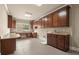 Well-equipped laundry room with granite countertops, custom cabinetry, stainless steel sink and tile flooring at 2845 Echols Rd, Cumming, GA 30041