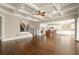 Open concept living room featuring hardwood floors, coffered ceiling, staircase, and kitchen access at 2845 Echols Rd, Cumming, GA 30041
