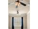 Living room features a ceiling fan, plush carpet, and large window with blue curtains at 2845 Echols Rd, Cumming, GA 30041