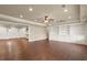Expansive living room with hardwood floors, built-in shelving, ceiling fan, and abundant recessed lighting at 2845 Echols Rd, Cumming, GA 30041