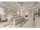 Inviting main bedroom featuring a tray ceiling, neutral tones, and a glimpse of the en-suite bathroom at 2845 Echols Rd, Cumming, GA 30041