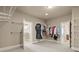 Large walk-in closet features custom shelving, hanging racks and has doorway views into an ensuite bathroom at 2845 Echols Rd, Cumming, GA 30041