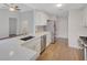 Kitchen with white cabinetry, stainless steel appliances, quartz countertops and hardwood floors at 3175 Justice Mill Nw Ct, Kennesaw, GA 30144