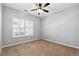 Carpeted bedroom featuring a ceiling fan and window with shutter-style blinds at 3310 Raes Creek Rd # 16, Marietta, GA 30008