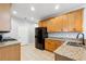 Traditional kitchen with wood cabinets, granite counters and black appliances at 3310 Raes Creek Rd # 16, Marietta, GA 30008