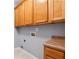 Laundry room features wooden cabinets and grey walls at 3310 Raes Creek Rd # 16, Marietta, GA 30008