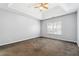 Spacious main bedroom with a tray ceiling, ceiling fan, and window with shutters at 3310 Raes Creek Rd # 16, Marietta, GA 30008