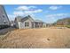 View of the home's backyard with privacy fence, grass, and screened in porch at 410 Windy Ridge Way, Canton, GA 30114