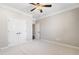 Spacious bedroom featuring plush carpeting, closet, and a ceiling fan at 410 Windy Ridge Way, Canton, GA 30114