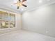 Serene bedroom showcasing neutral tones, a ceiling fan, and a large window for natural light at 410 Windy Ridge Way, Canton, GA 30114