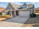 Charming home featuring a two-car garage, stone accents, and welcoming front porch at 410 Windy Ridge Way, Canton, GA 30114