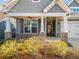 Inviting home front porch with stone columns and a ceiling fan at 410 Windy Ridge Way, Canton, GA 30114