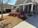 Charming home featuring a well-manicured yard with beautiful flowering bushes and inviting covered porch at 410 Windy Ridge Way, Canton, GA 30114