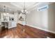 Open concept kitchen and dining area featuring modern appliances and hardwood floors at 410 Windy Ridge Way, Canton, GA 30114