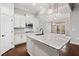 Bright kitchen featuring white cabinets, granite countertops, and stainless steel appliances at 410 Windy Ridge Way, Canton, GA 30114