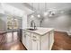 Kitchen island with granite countertop and pendant lighting, open to adjacent living spaces at 410 Windy Ridge Way, Canton, GA 30114