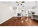 Open-concept living room with hardwood flooring, fireplace, and kitchen with stainless steel appliances at 410 Windy Ridge Way, Canton, GA 30114