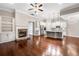 Open-concept living room with hardwood flooring, fireplace, and kitchen with stainless steel appliances at 410 Windy Ridge Way, Canton, GA 30114
