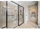 A bathroom features a large glass shower, tile flooring, and tile shower with black trim at 410 Windy Ridge Way, Canton, GA 30114