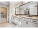 Main bath features double vanity, granite countertops, tile flooring, large mirror, and natural lighting at 410 Windy Ridge Way, Canton, GA 30114
