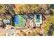 Aerial view showcasing community amenities, including tennis courts, a pool, playground, parking, and access to the lake at 257 Lakestone Pkwy, Woodstock, GA 30188