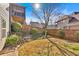 View of a private backyard featuring a well-maintained fence, a small rock garden, and healthy green landscaping at 257 Lakestone Pkwy, Woodstock, GA 30188