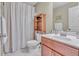 Bathroom with a vanity, mirror, toilet, and shower with patterned curtain at 257 Lakestone Pkwy, Woodstock, GA 30188