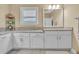 A primary bathroom with granite countertops, tile flooring, and updated lighting at 257 Lakestone Pkwy, Woodstock, GA 30188