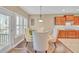 A dining area featuring a light fixture, plantation shutters and a door leading to the backyard at 257 Lakestone Pkwy, Woodstock, GA 30188