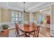 Bright dining room features hardwood floors, wainscoting, and an elegant chandelier at 257 Lakestone Pkwy, Woodstock, GA 30188