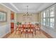 Formal dining room with tray ceiling, plantation shutters, and ample seating for Gathering gatherings at 257 Lakestone Pkwy, Woodstock, GA 30188