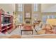 Open living room features a floor-to-ceiling stone fireplace and large windows at 257 Lakestone Pkwy, Woodstock, GA 30188
