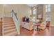 The open living room features a soaring stone fireplace and hardwood floors at 257 Lakestone Pkwy, Woodstock, GA 30188