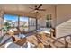 Inviting screened-in porch with fan, comfortable seating, and views of the neighborhood at 257 Lakestone Pkwy, Woodstock, GA 30188
