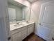 This bathroom features double sinks and a large mirror at 2624 Mourning Dove Drive (Lot 42), Grayson, GA 30017