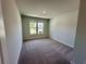 Cozy bedroom with neutral carpeting, a bright window, and freshly painted walls at 2624 Mourning Dove Drive (Lot 42), Grayson, GA 30017