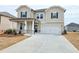 Beautiful home with an attached garage, showcasing a well-maintained lawn and inviting curb appeal at 2624 Mourning Dove Drive (Lot 42), Grayson, GA 30017