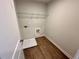This utilitarian laundry room has vinyl floors and a wire rack shelf at 2624 Mourning Dove Drive (Lot 42), Grayson, GA 30017