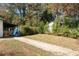 Long driveway leading to the backyard with mature trees and landscaping providing shade at 368 Triumph Se Cir, Atlanta, GA 30354