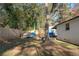 Landscaped backyard featuring a wooden fence, mature trees, and a fire pit at 368 Triumph Se Cir, Atlanta, GA 30354