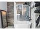A luxurious bathtub, tile accent wall and modern showerhead create a spa-like bathroom at 368 Triumph Se Cir, Atlanta, GA 30354