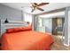 A Primary bedroom with an orange bed, modern headboard, barn door and decorative dream catcher at 368 Triumph Se Cir, Atlanta, GA 30354