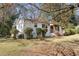 Charming two-story home with white painted brick, a covered porch, and mature trees at 368 Triumph Se Cir, Atlanta, GA 30354