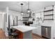 Modern kitchen featuring an island, stainless steel appliances, and white subway tile backsplash at 368 Triumph Se Cir, Atlanta, GA 30354