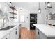 Modern kitchen with an island, stainless steel appliances, and conveniently located laundry area at 368 Triumph Se Cir, Atlanta, GA 30354