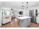 Open-concept kitchen with a large island, seating, and seamless flow into the living room at 368 Triumph Se Cir, Atlanta, GA 30354