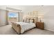 A primary bedroom showcases a large window, decorative pillows, and a wooden nightstand at 452 Reflection Dr # 19, Stockbridge, GA 30281
