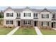 New construction townhomes feature mixed material facade, black shutters and professionally maintained lawn at 452 Reflection Dr # 19, Stockbridge, GA 30281