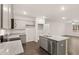Modern kitchen boasts a granite island, stainless appliances, and gray cabinets at 452 Reflection Dr # 19, Stockbridge, GA 30281